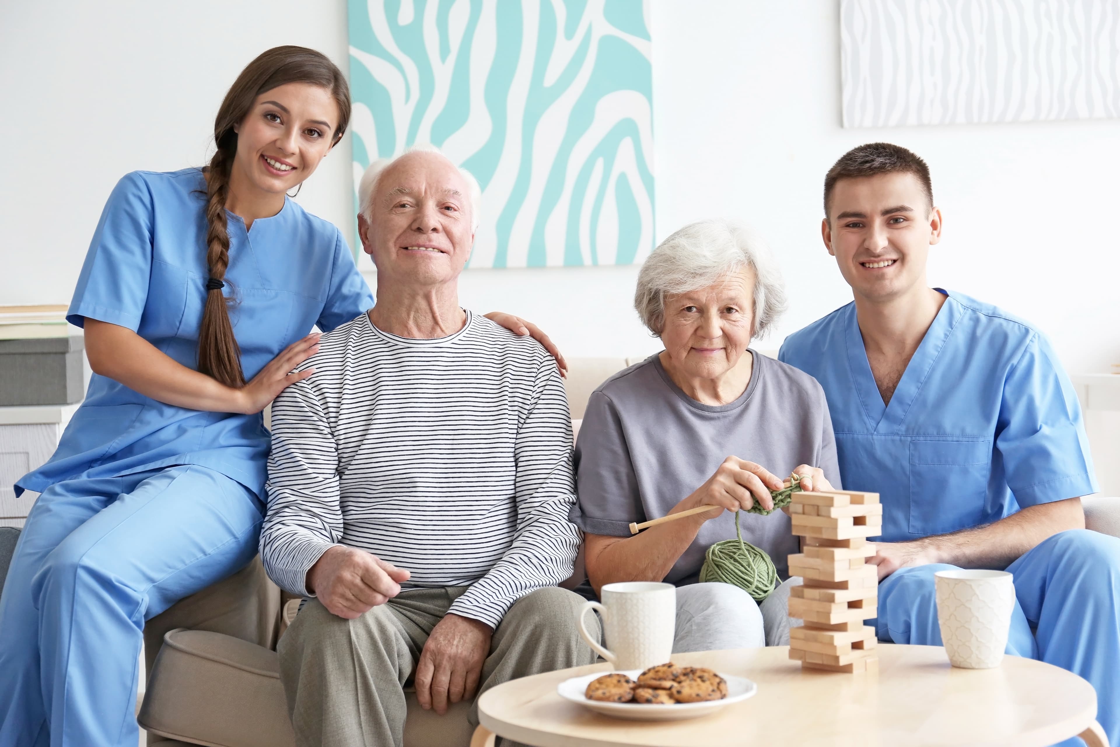 Senior couple with dedicated caregivers at home